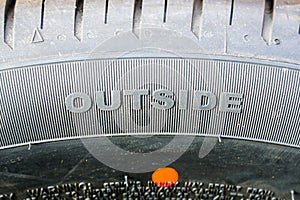 Sidewall of a passenger car tire with an outer side marking photo