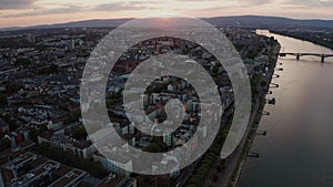 Sideways move of a drone showing the Dome with the Rhine river with cargo ships and reflections on the water and old bridge in