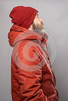 Sideways portrait of man in winter coat freezing in the cold