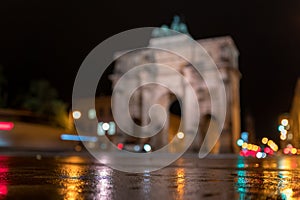 The Siegestor Victory Arch in Munich. Triumphal arch at night on a rainy day. Side view, blurred version with bokeh