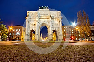 The Siegestor (Victory Gate) at night in Munich photo