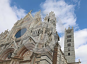 Siena Cathedral with bell tower and statua of wolf called LUPA in Italy