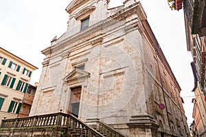 Exterior view of San Martino Church next to La Loggia in Siena, Tuscany, Italy