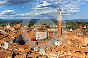 Siena, Italy rooftop city panorama. Mangia Tower, Italian Torre del Mangia