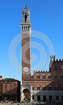 Siena Italy Tower called TORRE DEL MANGIA and the Cappella a marble tabernacle at the foot of the tower photo