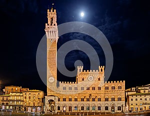 Siena, Tuscany, Italy: night view of the ancient town hall Palazzo Pubblico and the tower Torre del Mangia