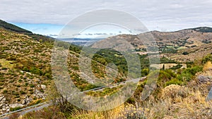 Sierra de Gredos mountain landscape with winding road, Spain.