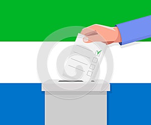 Sierra Leone election concept. Hand puts vote bulletin