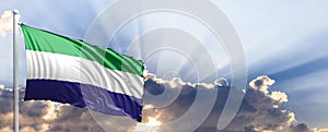 Sierra Leone flag on blue sky. 3d illustration