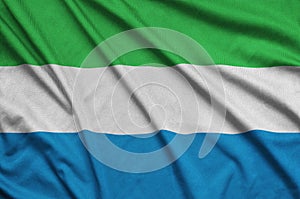 Sierra Leone flag is depicted on a sports cloth fabric with many folds. Sport team banner