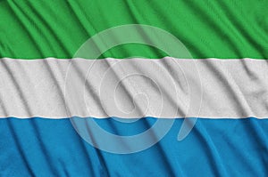Sierra Leone flag is depicted on a sports cloth fabric with many folds. Sport team banner photo