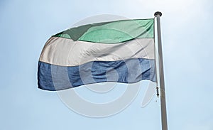 Sierra Leone flag waving against clear blue sky