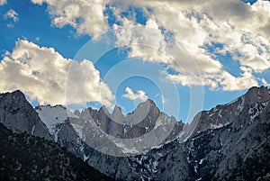 Sierra Nevada Mountains peaking into a partly cloudy sky.