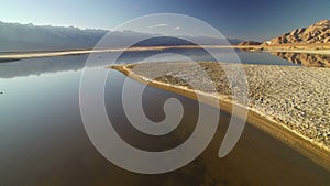 Sierra Nevada Mountains Range Reflections on Owens Lake California Sunset Aerial Shot Forward