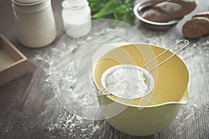 Sieve flour and flour on mixing bowl.