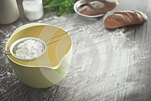 Sieve flour and flour on mixing bowl.