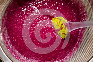 Sieving raspberry puree