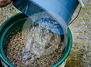 Sift and classify mineral rich soil with gold panning classifier pan.