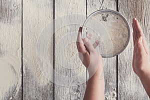 Sift flour top view on rustic wood background