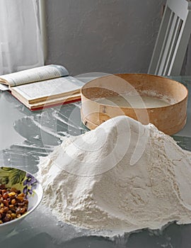 sifted flour, raisins, sieve, recipe book