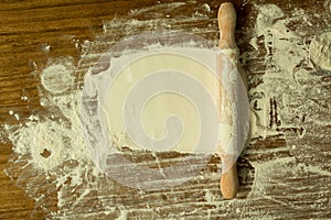 Sifted flour and rolling pin on the table