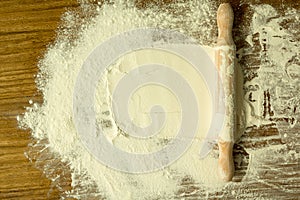 Sifted flour and rolling pin on the table