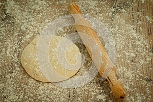 Sifted flour on the table and a rolling pin