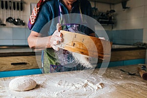 Sifting flour on the dough