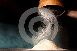 Sifting flour from old sieve.