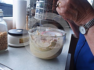 Sifting flour into the recipe