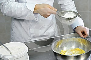 Sifting the flour through a sieve