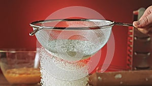 Sifting flour through sieve slow motion