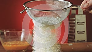 Sifting flour through sieve slow motion