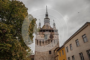 Sighisoara Clock Tower Turnul cu Ceas during a cloudy fall afternoon. It is the main entrance of Sighisoara castle, in Romania