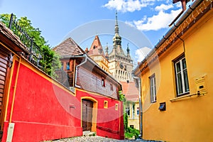 Sighisoara, Romania. Medieval street with Clock Tower in Transylvania.