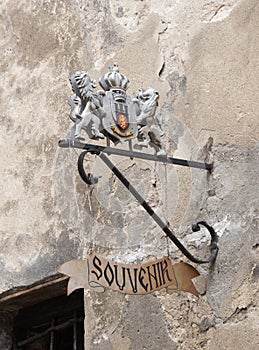 Decorative coat of arms above the entrance to the souvenir shop in Sighisoara city in Romania