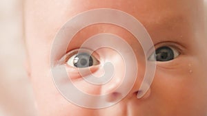 Sight of a newborn baby child`s eyes macro baby look close up shot