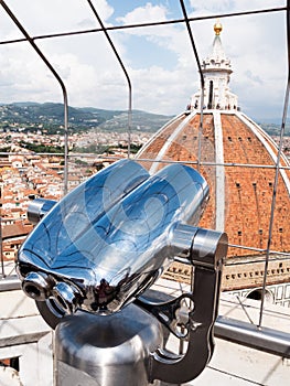 Sightseeing binoculars pointing to the Dome of Florence