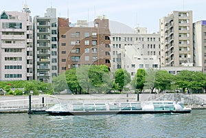 Sightseeing boat Japan river, residential apartment