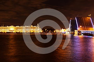 Sightseeing in the city of St. Petersburg in Russia, the Neva river with the raised Palace bridge at night