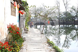 Rustic street along the lake in water village Hongcun, China