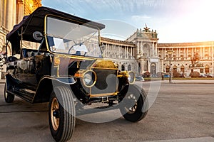 Sightseeing unrecognizable golf electric car styled as vintage retro vehicle for tourist city tour against Vienna