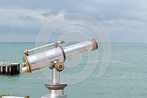 Sightseeing Vintage coin operated binocular overlooking for viewer ocean sea Beach