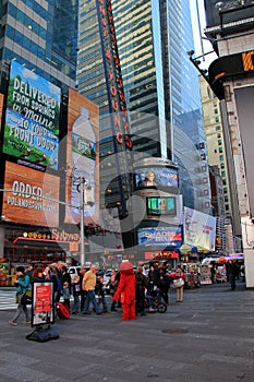 Sightseers having pictures taken with costumed characters,Times Square,NYC,2015