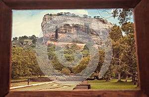 Sigiriya mountain and people walking to famous historical and archaeological site. Photo frame and UNESCO heritage area