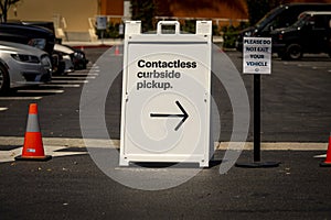Sign advertising Contactless Curbside Pickup at retail retail store parking lot