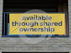 Sign advertising new apartments available through shared ownership photo