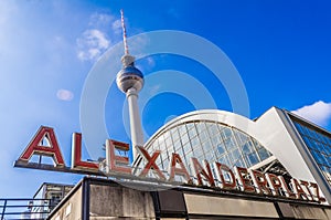 Sign on the Alexanderplatz Hauptbahnhof with the famous TV tower in the background