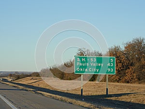 Sign along Interstate Highway 35 with distance to Pauls Valley and Oklahoma City