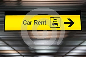 Sign with arrow point to rent a car service at the airport